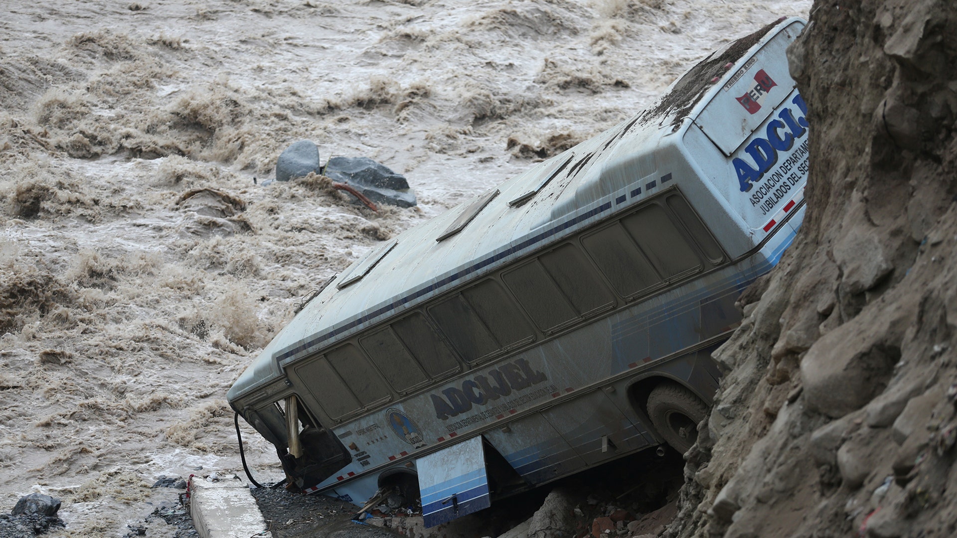 A bus is seen after a landslide and flood in Chosica, east of Lima, Peru 