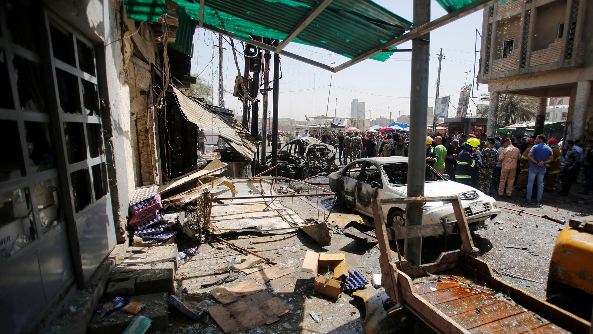 Damaged shops are seen at the site of car bomb attack near a government office in Karkh district in Baghdad