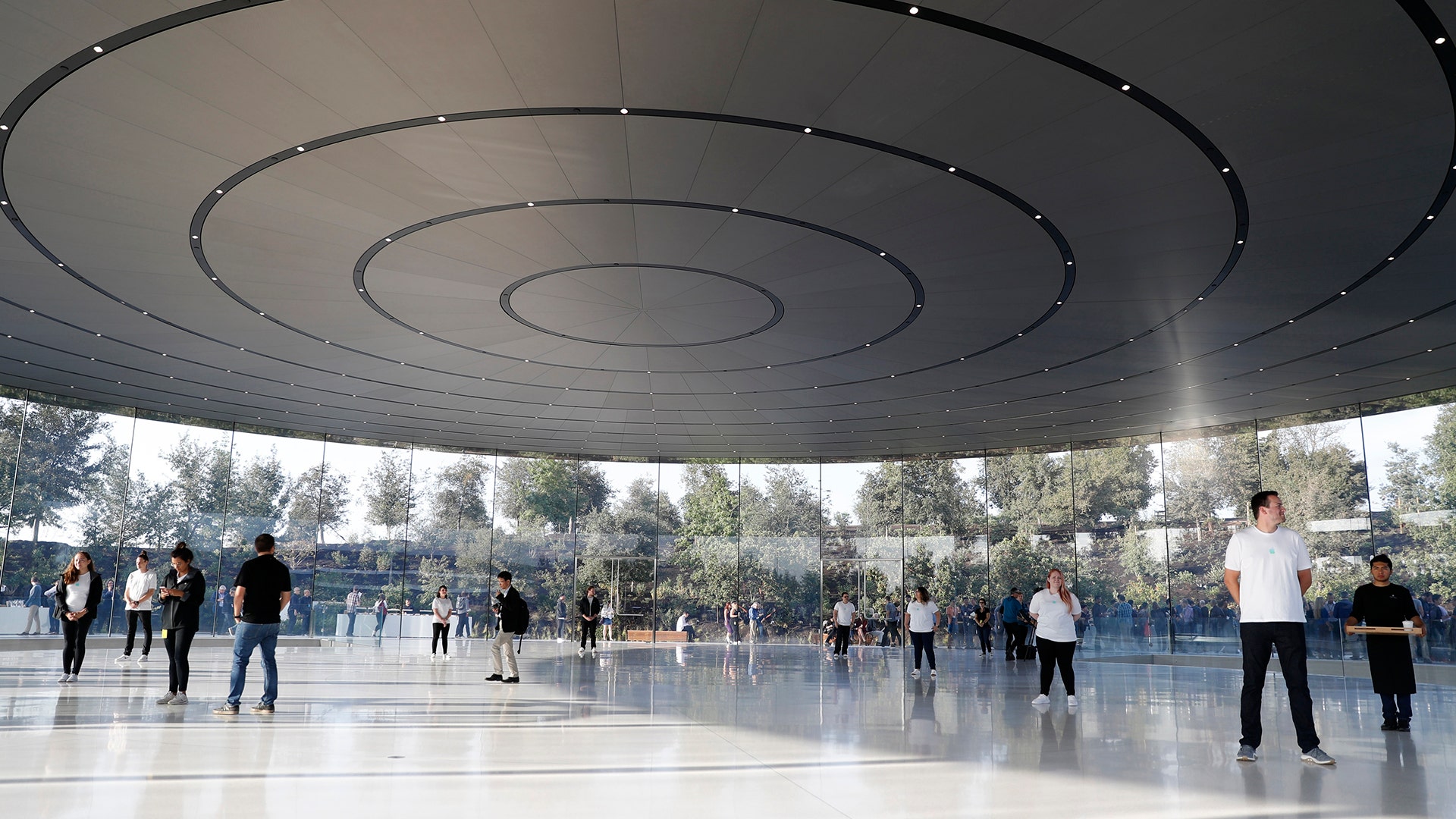 People await the start of a product launch event at Apple's new campus in Cupertino, California, Tuesday
