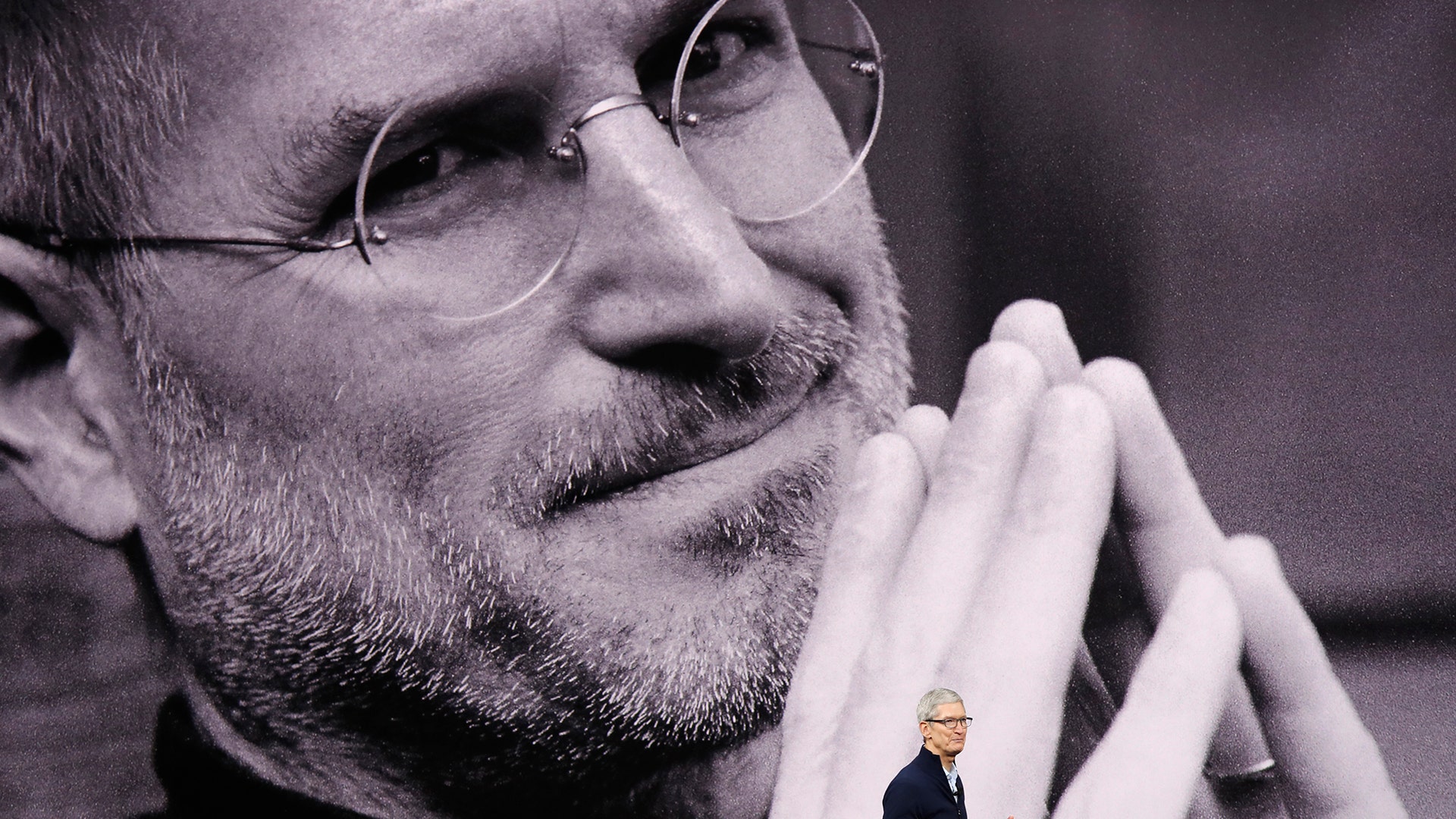 Tim Cook, CEO of Apple, speaks as a tribute to the late Apple co-founder Steve Jobs plays during a product launch in Cupertino, California