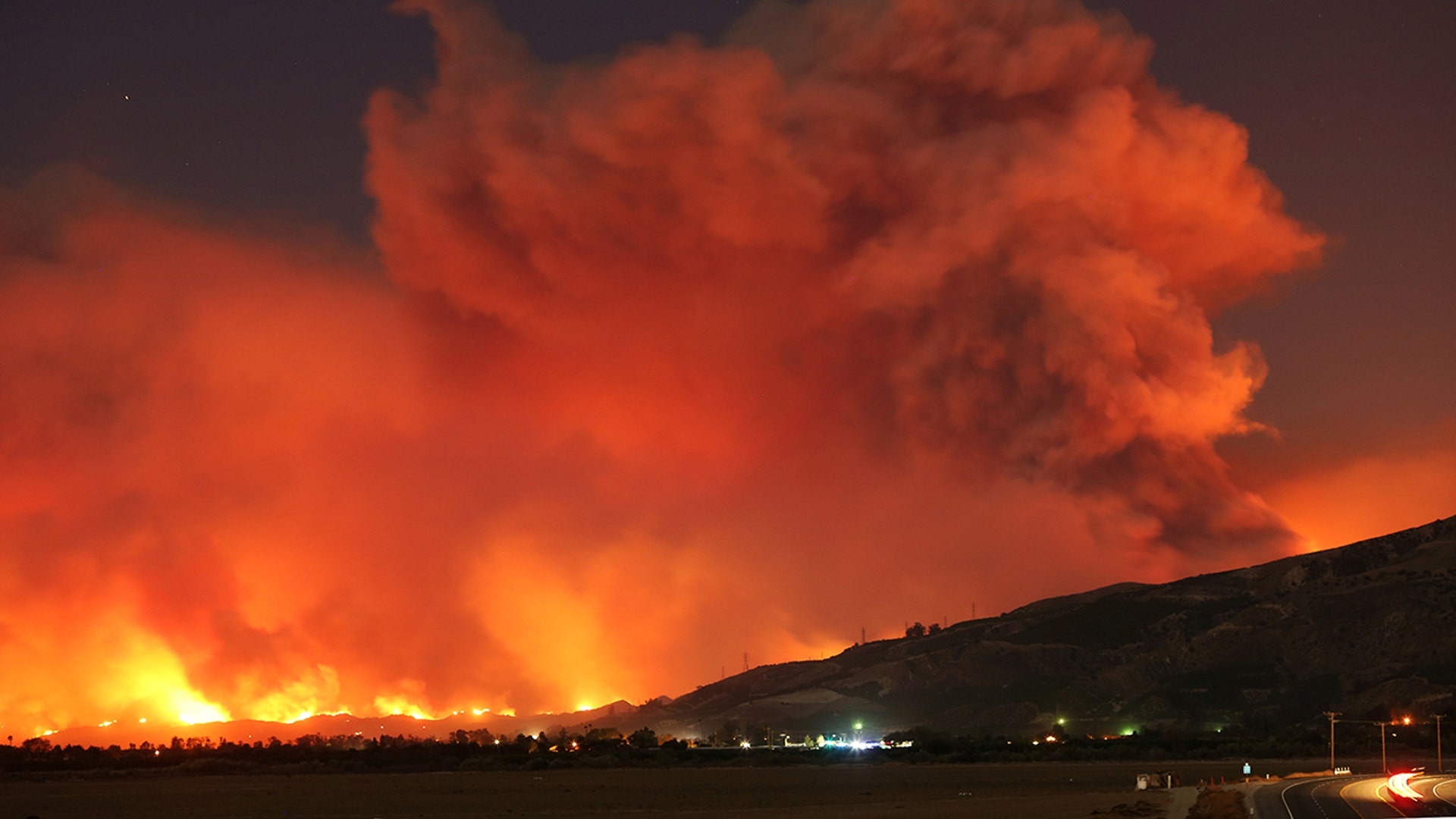 Smoke rises into the night sky as strong winds push the Thomas Fire across thousands of acres near Santa Paula, California