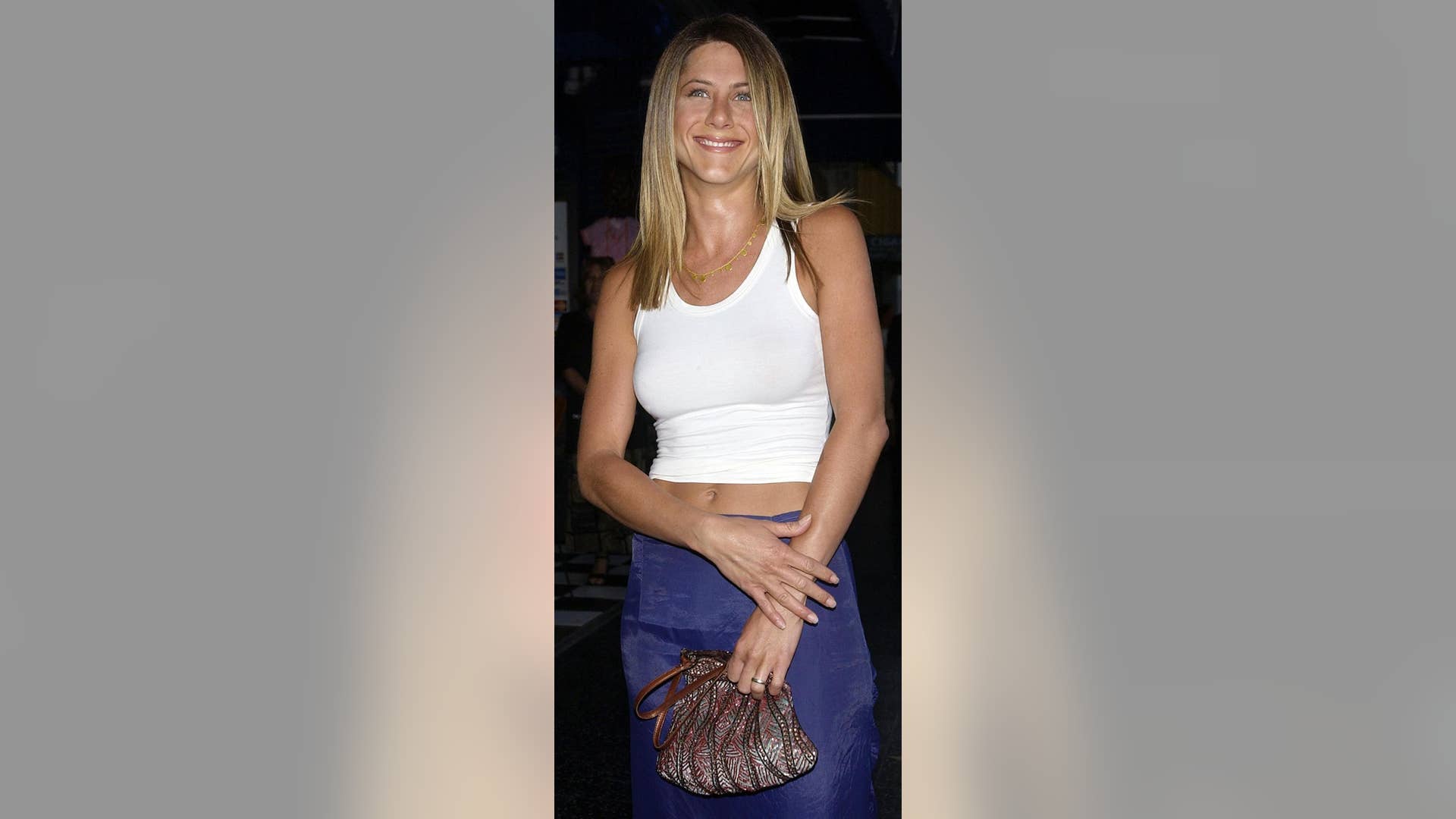Aniston looked effortlessly stylish — while rocking an amazing figure — in a basic white tank and a shiny navy skirt.