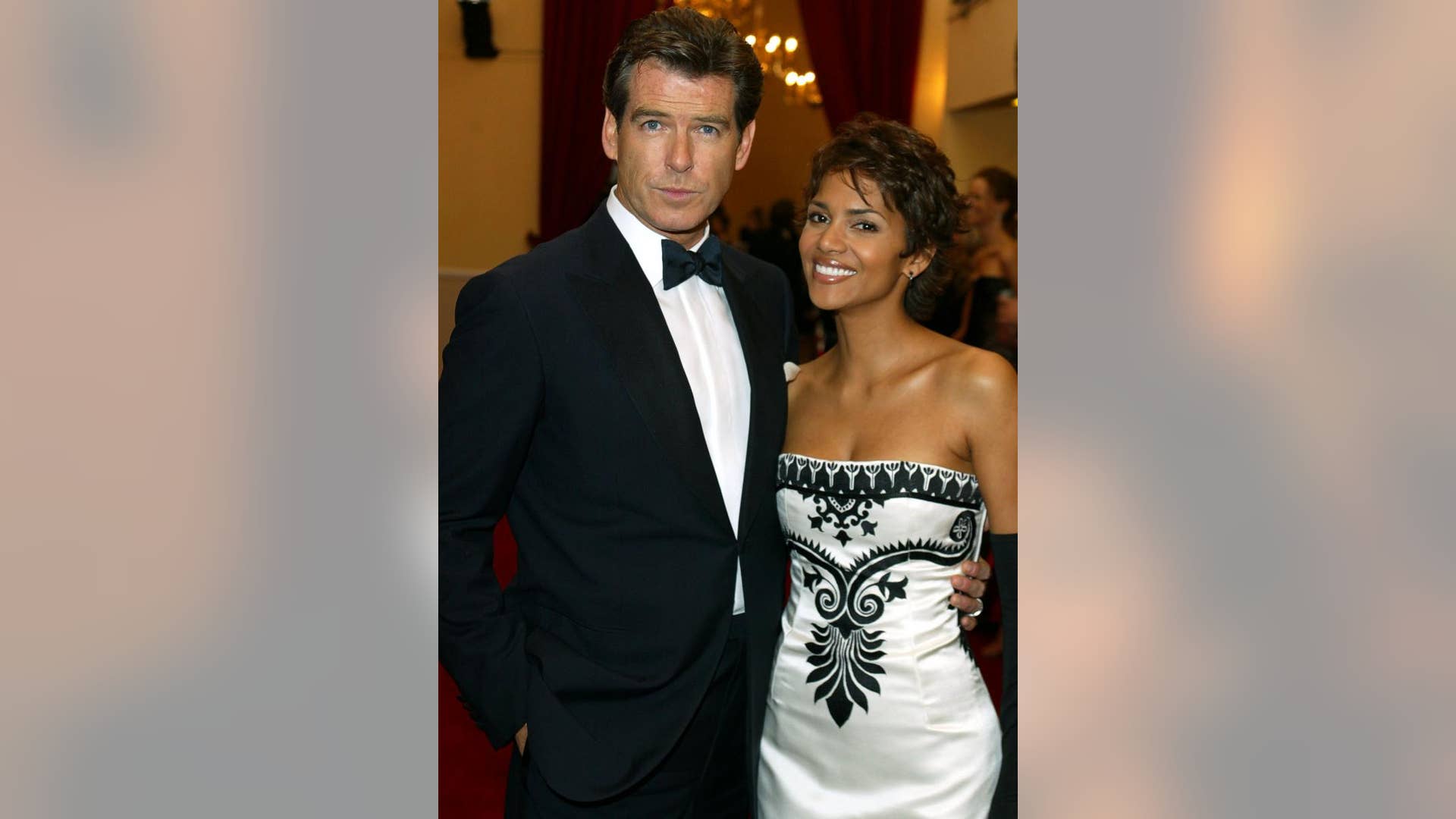 Getting cozy with actress Halle Berry in London on November 18, 2002.