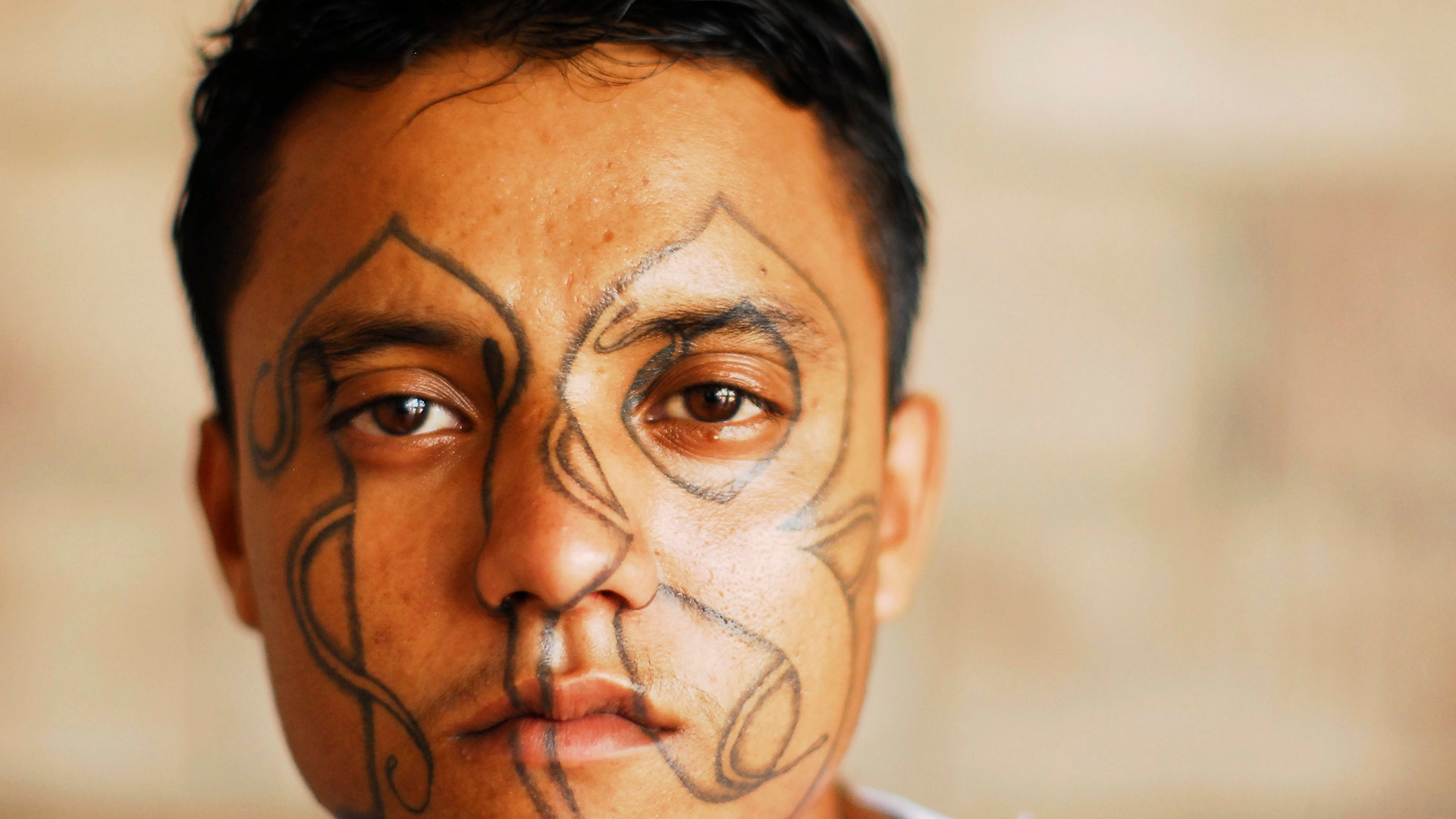 An imprisoned member of street gang Mara 18 poses for a photograph at the Izalco prison