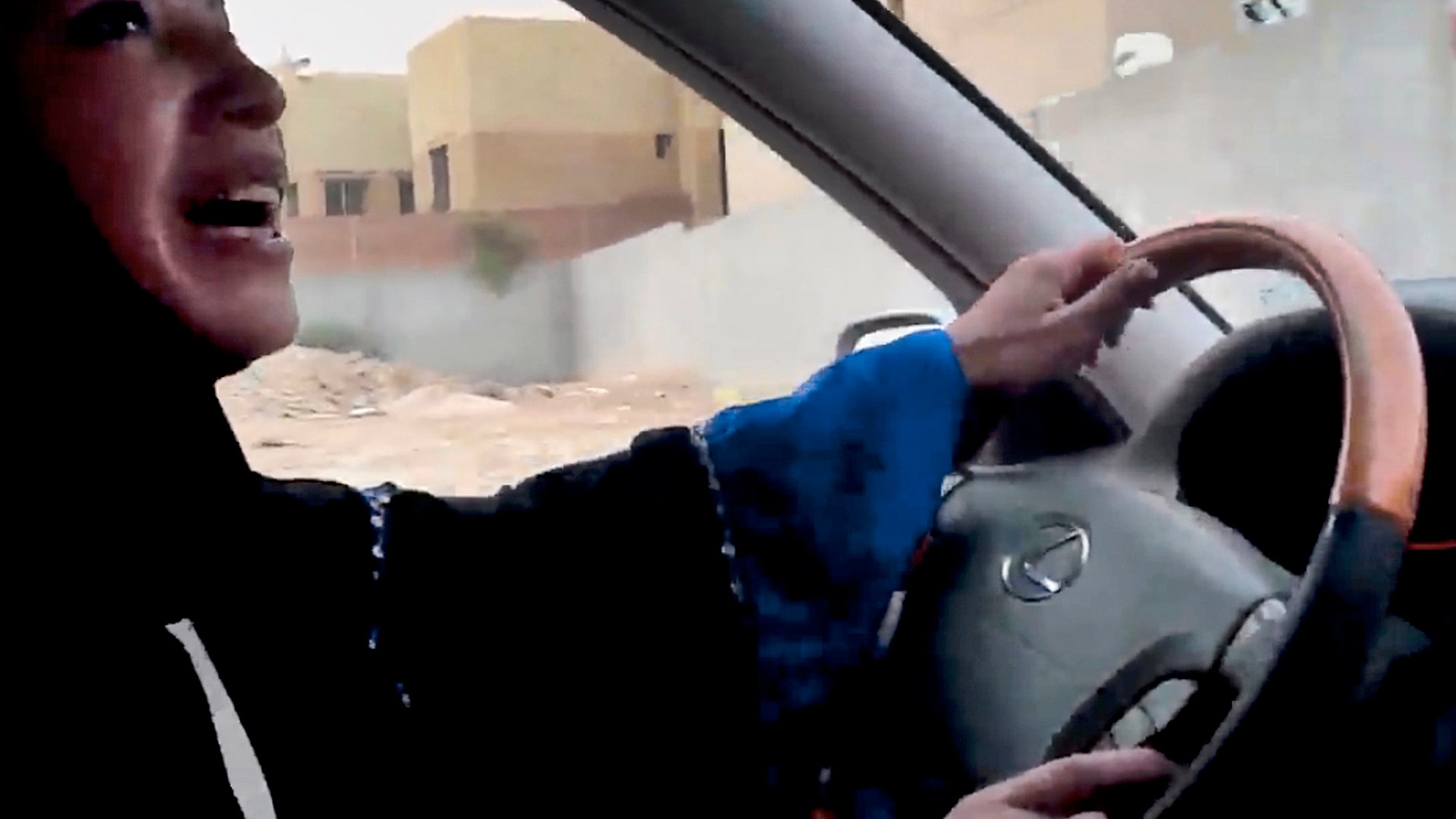 A Saudi Arabian woman drives a car as part of a campaign to defy Saudi Arabia's ban on women driving, in Riyadh, Saudi Arabia, June 17, 1998