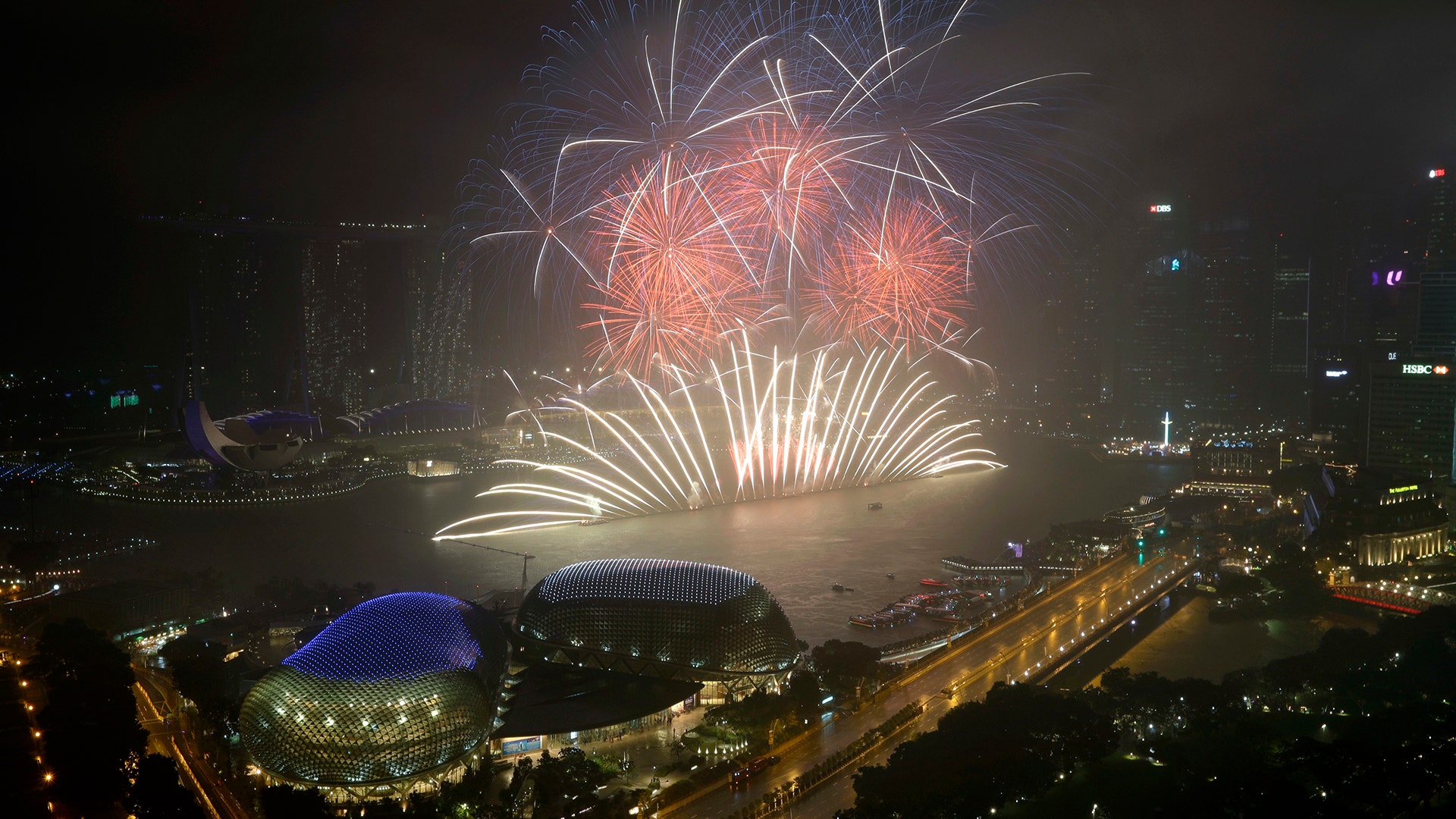 Fireworks explode above Singapore's financial district at the stroke of midnight to mark the New Year's celebrations 