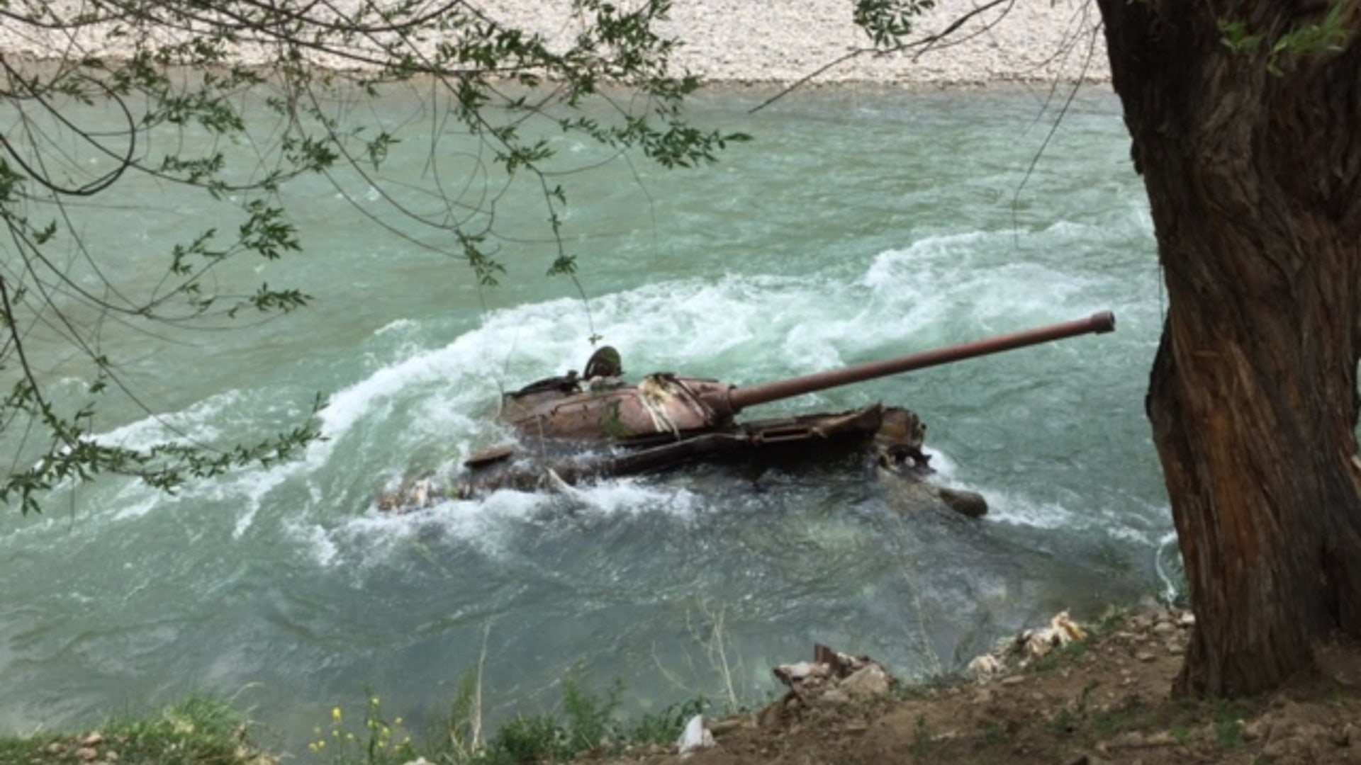 The rusting hulk of a partially submerged Russian tank, one of many used by the Soviets when they invaded Afghanistan in 1979.