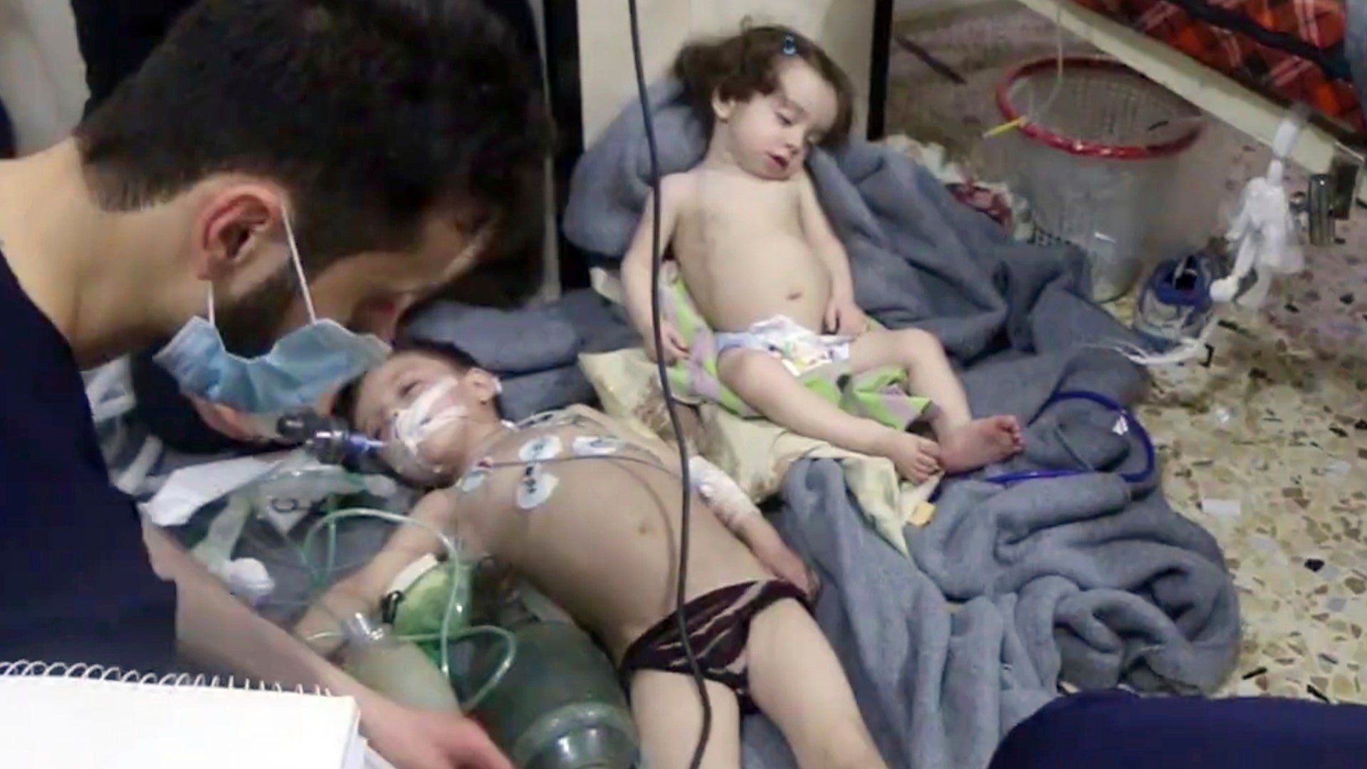 Medical workers treat toddlers following a suspected poison gas attack in the opposition-held town of Douma.