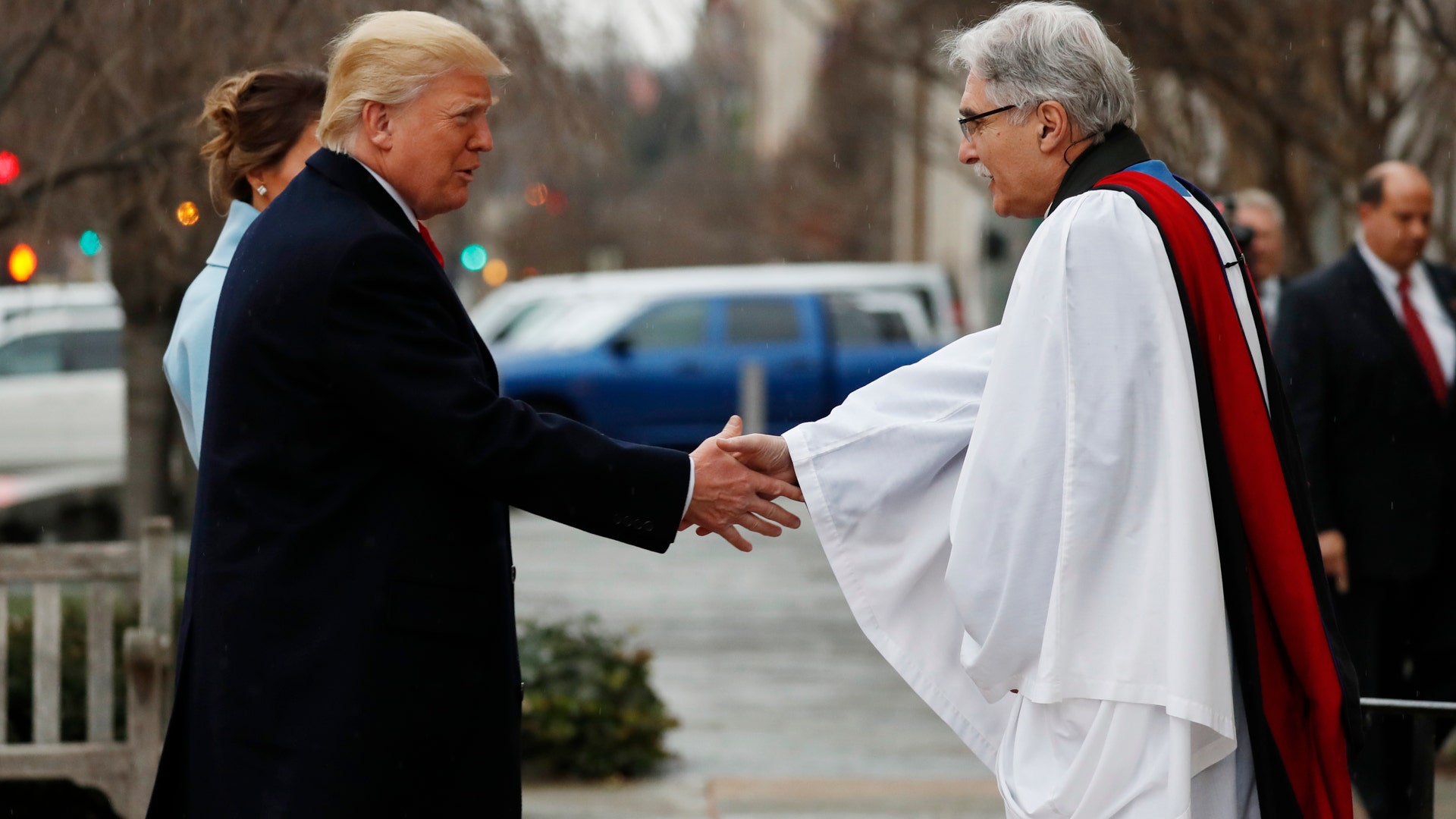 Rev Luis Leon greets President-elect Donald Trump and his wife Melania as they arrive for a church service at St. John’s Episcopal Church across from the White House in Washington, Friday, Jan. 20, 2017, on Donald Trump's inauguration day. (AP Photo/Alex Brandon)