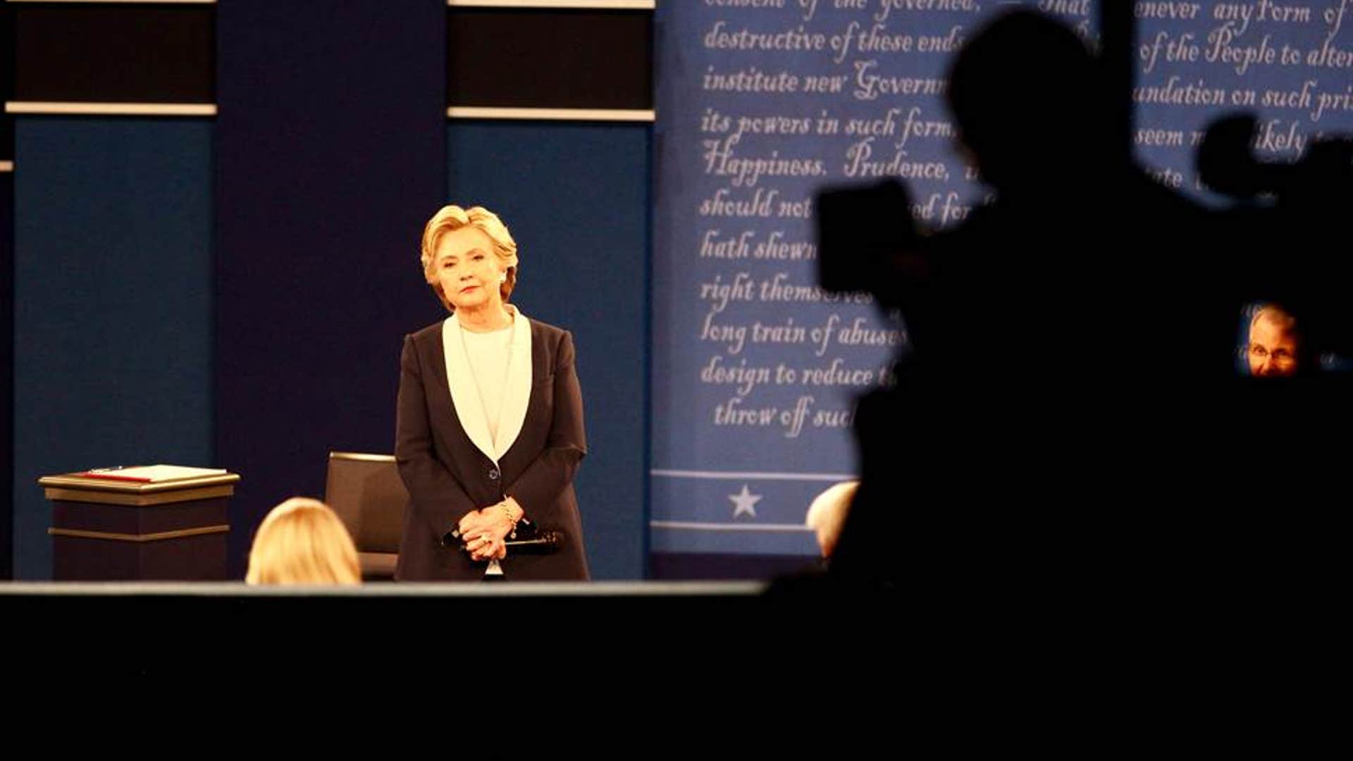 Hillary Clinton listens to a question from the moderators.