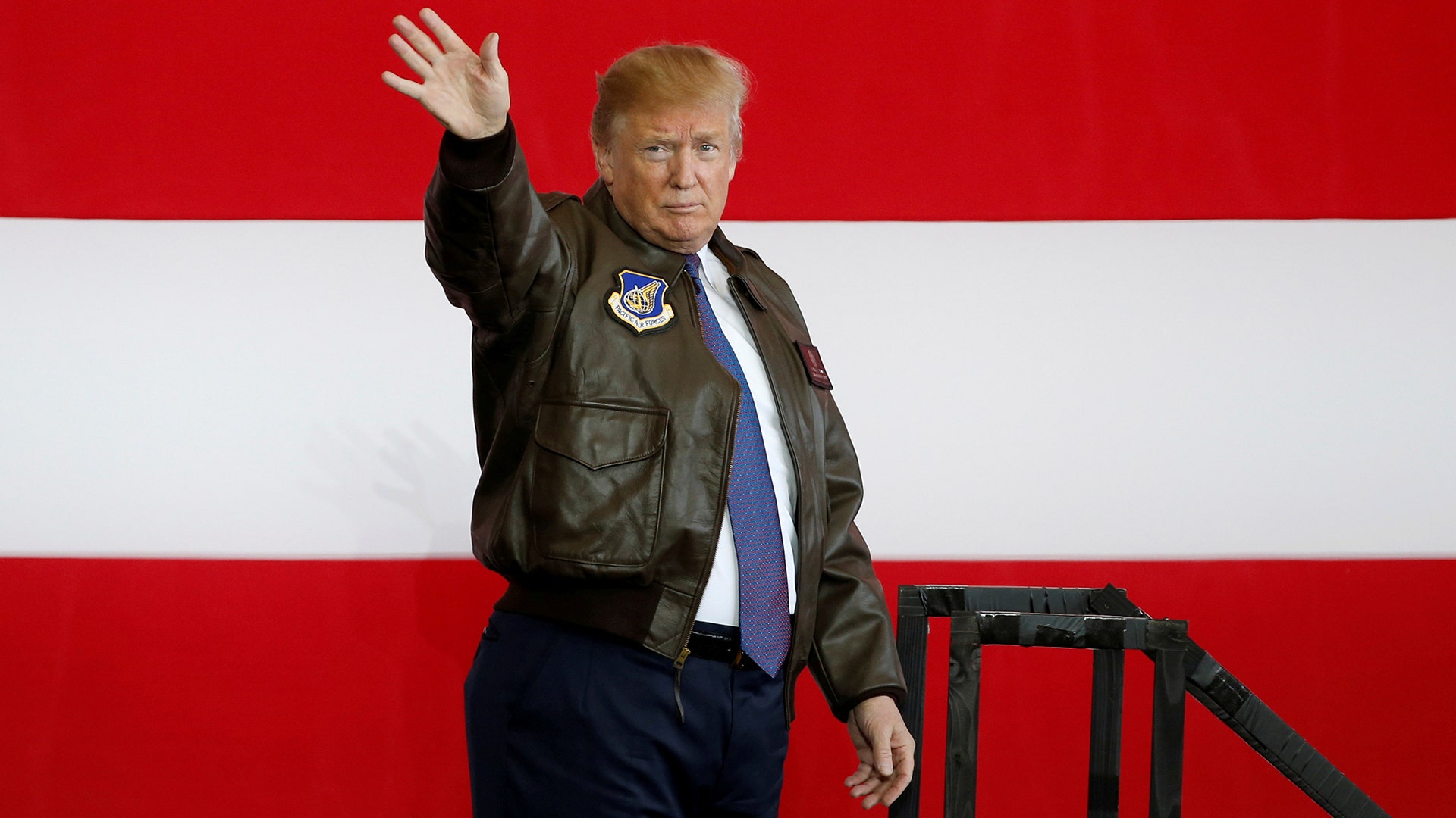 President Trump waves to U.S. military service members and Japan Self-Defense Forces.