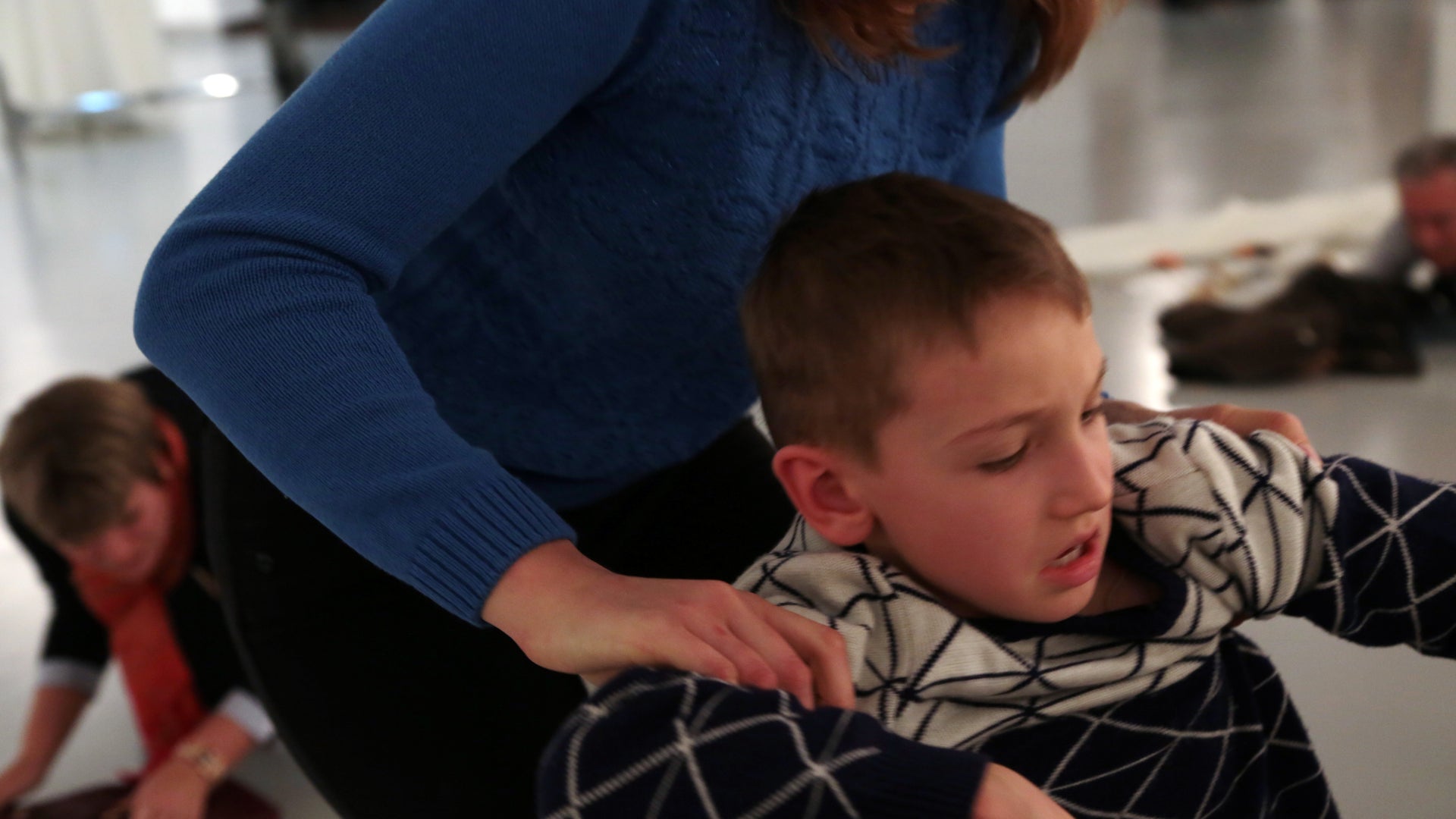 This woman is shown comforting a child in the aftermath of the chilling incident.