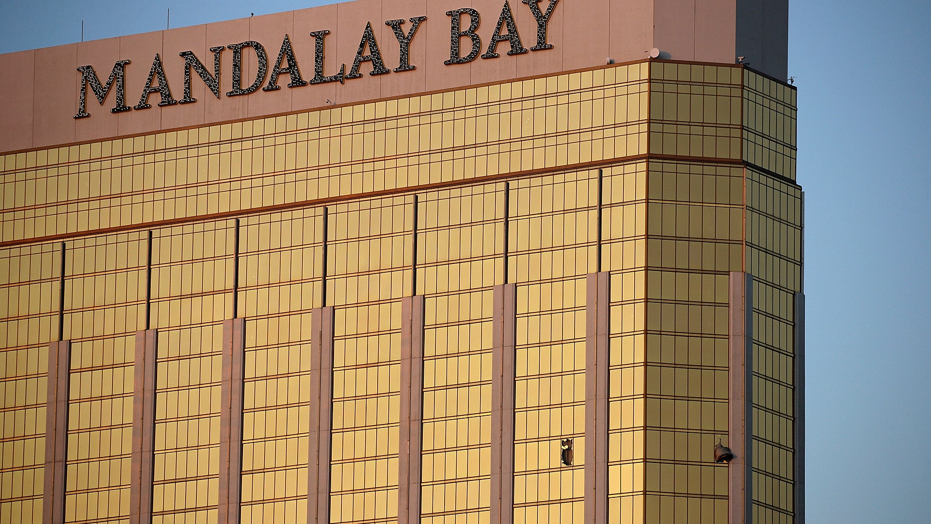 Drapes billow out of broken windows at the Mandalay Bay resort Monday, following a deadly shooting in Las Vegas