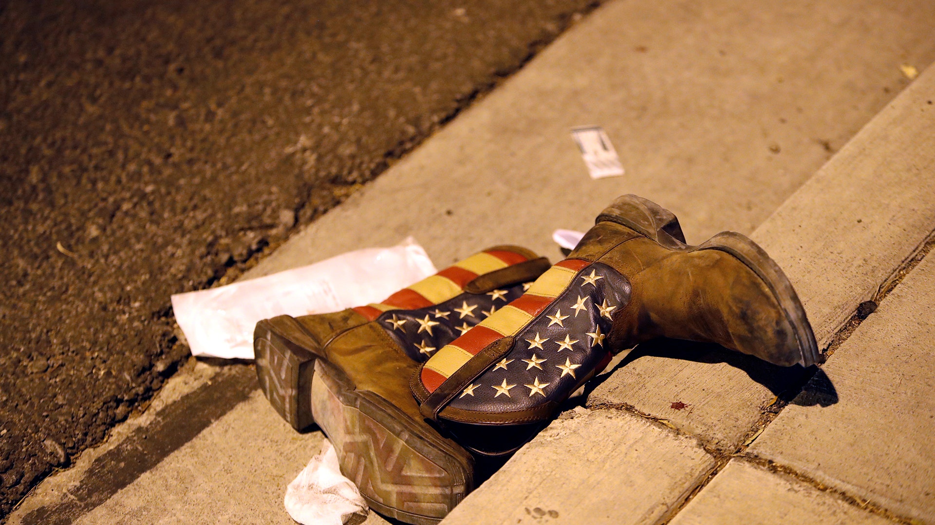 A pair of cowboy boots in the street outside the concert venue after a mass shooting at a music festival on the Las Vegas Strip, Sunday