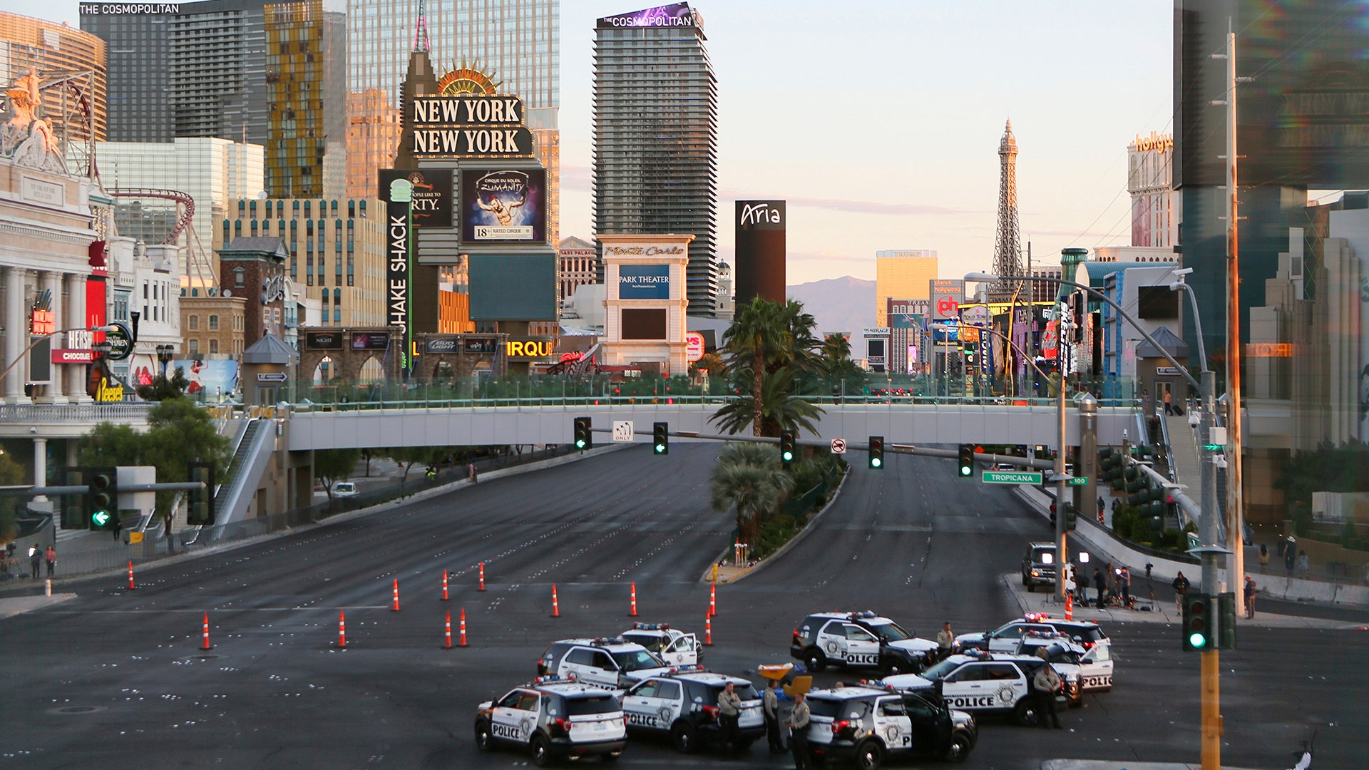 A roadblock is shown through a gap in a glass partition at the corner of Las Vegas Boulevard and Tropicana Avenue
