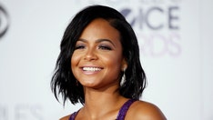 Christina Milian shows off muscular abs in tiny snakeskin thong bikini