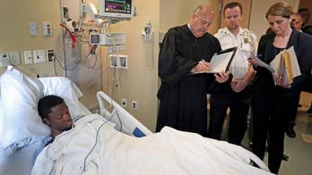 The Latest: Suspect in doctors' deaths faces murder charges