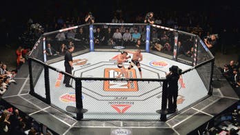 Amateur fighters crash through a cage door, one suffers injury