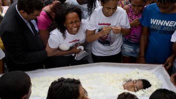 Rio slum residents bury teen, protest police-gang shootouts