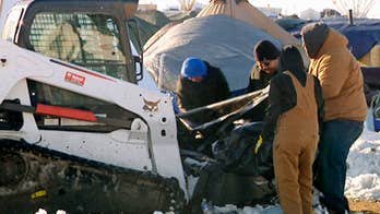 Authorities search for dead bodies in massive garbage chunks left at protest site