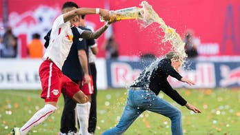 Leipzig head coach pulls hamstring trying to avoid beer shower