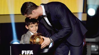 Cristiano Ronaldo shows his son how to pose in a towel