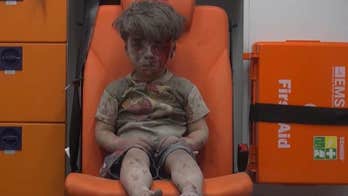 Haunting image of Syrian boy rescued from Aleppo rubble after airstrike