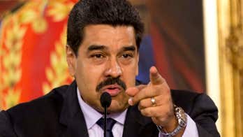 Venezuela leader Maduro met with insults by angry protesters during island visit