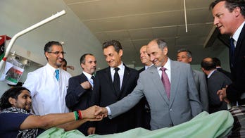 U.K.'s Cameron, France's Sarkozy Pledge Billions for Libya