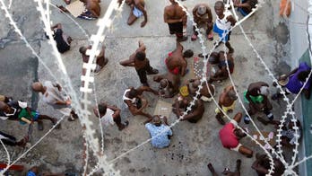 Mass funeral held for 20 Haitians who died in dismal prison