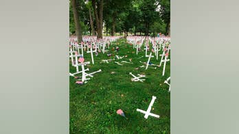 Police: Man drives through Kentucky memorial cross display