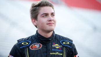 Champion race car driver left hanging as model ducks victory kiss