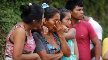 Families in flood-hit Colombian city search for children