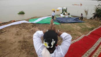 Cambodians ask spirits to help recover statues from river