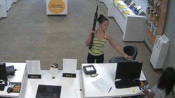 Rifle-wielding woman caught on video robbing Sprint store