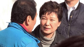 South Korean leader makes rare public appearance as scandals threaten presidency