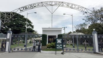 Despite protests, Marcos is buried at heroes' cemetery