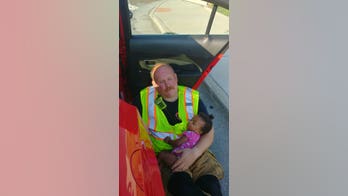 Photo of Tennessee firefighter cradling little girl after car accident goes viral