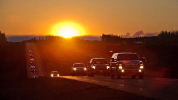 Canadian convoy waits for dawn, hoping to flee wildfire zone