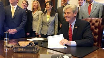 Mississippi governor signs law allowing armed church members