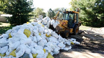 The Latest: Forecasters expect lower crest on flooded river