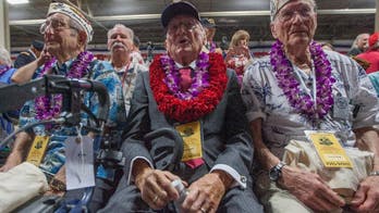 The Latest: Guests observe moment of silence at Pearl Harbor