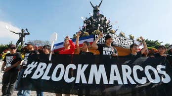 Protesters mark Philippine revolt by condemning killings