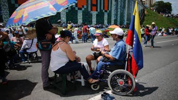 Venezuelans again shut down capital to protest government
