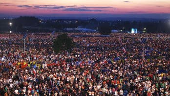 Faithful fill meadow ahead of pope's last Mass in Poland