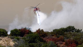 Firefighters battle California brushfire as heatwave looms
