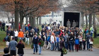 Volunteers place more than 240,000 wreaths at graves at Arlington National Cemetery