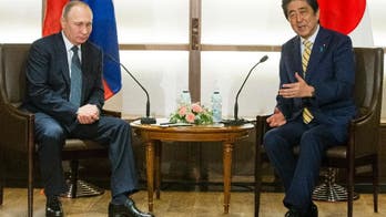 The Latest: Abe visits father's grave ahead of Putin visit