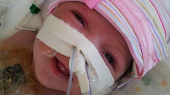 Baby born with heart outside of body finally leaves hospital