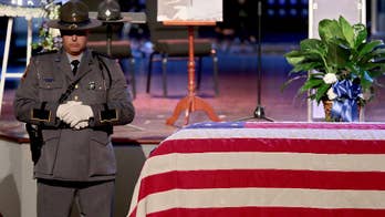 Thousands mourn Va. trooper killed in Greyhound bus station shooting